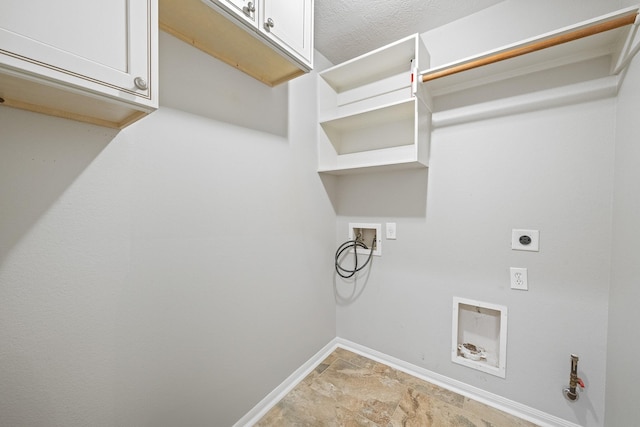 washroom with washer hookup, a textured ceiling, cabinet space, baseboards, and hookup for an electric dryer