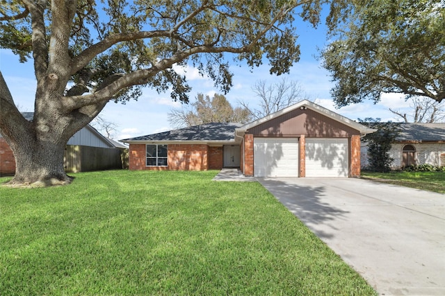 view of front facade with a garage, a front yard, brick siding, and driveway