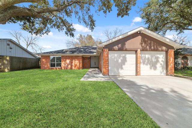 view of front of house with a garage, a front yard, brick siding, and driveway