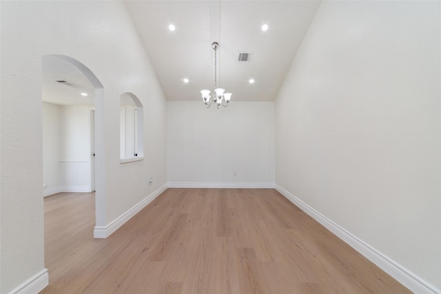 spare room featuring arched walkways, recessed lighting, visible vents, baseboards, and light wood-style floors