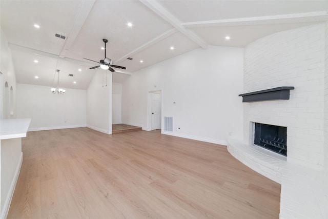 unfurnished living room featuring beam ceiling, a brick fireplace, visible vents, and light wood-style floors