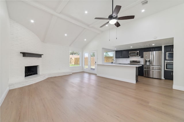 unfurnished living room featuring a fireplace, light wood-style floors, ceiling fan, high vaulted ceiling, and baseboards