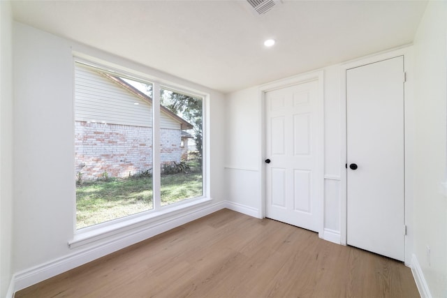 unfurnished bedroom with recessed lighting, visible vents, light wood-style flooring, and baseboards