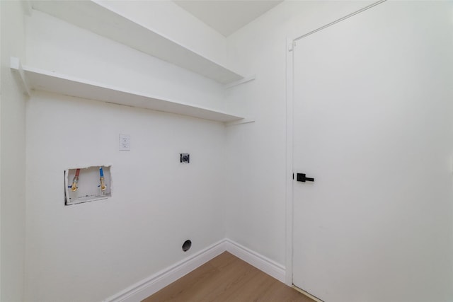 clothes washing area with hookup for an electric dryer, laundry area, washer hookup, baseboards, and light wood finished floors