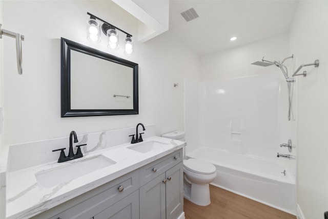 bathroom with visible vents, a sink, toilet, and wood finished floors