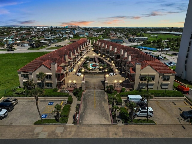 aerial view at dusk featuring a residential view