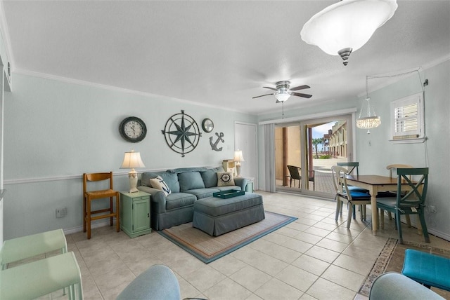 living room with ornamental molding, ceiling fan, baseboards, and light tile patterned floors