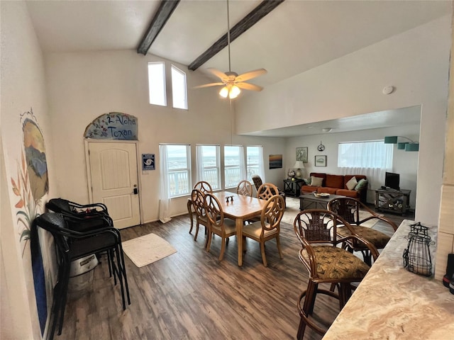 dining room featuring ceiling fan, high vaulted ceiling, wood finished floors, and beamed ceiling