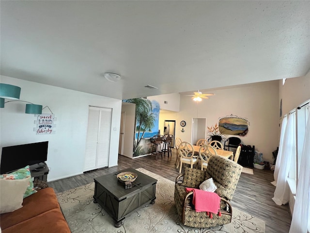 living room featuring visible vents, a ceiling fan, and wood finished floors