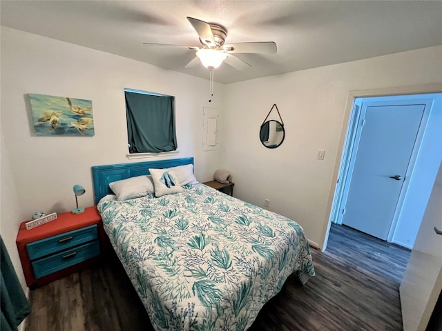 bedroom with a ceiling fan, baseboards, and wood finished floors