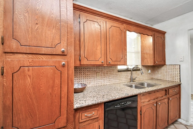 kitchen with black dishwasher, brown cabinets, a sink, and decorative backsplash