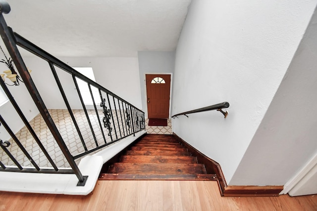 staircase featuring wood finished floors