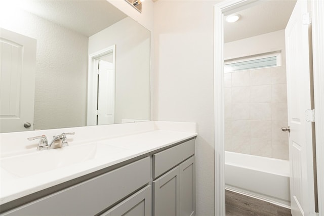 full bathroom featuring shower / bathing tub combination, wood finished floors, and vanity