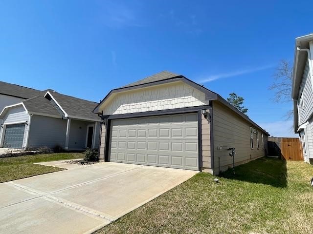 ranch-style house with an attached garage, driveway, a front yard, and fence