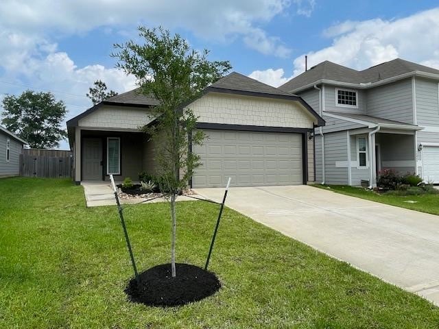 14041 Lamprey Dr, Conroe, TX 77384 - view of front of home featuring a garage, driveway, and a front yard