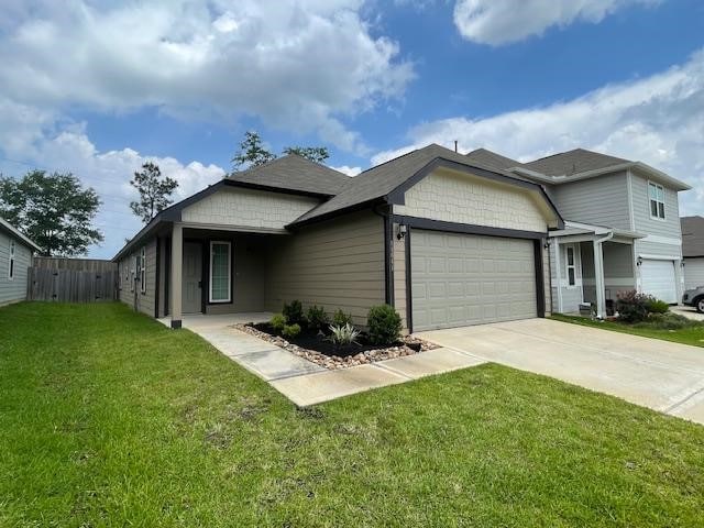 14041 Lamprey Dr, Conroe, TX 77384 - view of front facade with an attached garage and concrete driveway