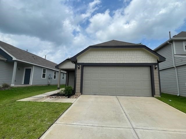 14041 Lamprey Dr, Conroe, TX 77384 - ranch-style house featuring concrete driveway, a front lawn, and a garage