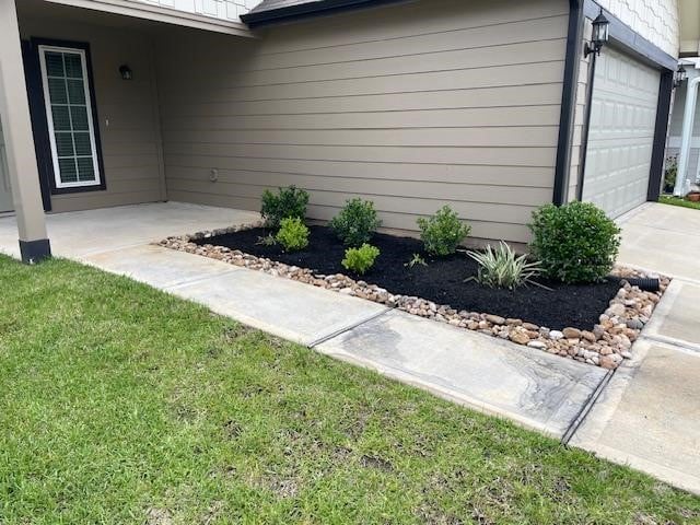 14041 Lamprey Dr, Conroe, TX 77384 - view of home's exterior with concrete driveway and an attached garage
