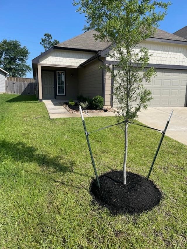 14041 Lamprey Dr, Conroe, TX 77384 - view of front facade with a garage, concrete driveway, and roof with shingles