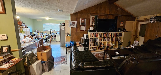 tiled living room featuring a textured ceiling, wood walls, vaulted ceiling, and visible vents