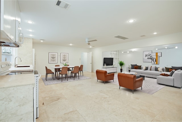 living area featuring recessed lighting, visible vents, and ceiling fan