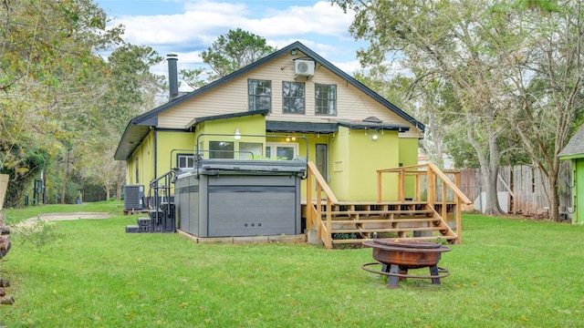 rear view of property with central AC, a yard, and fence