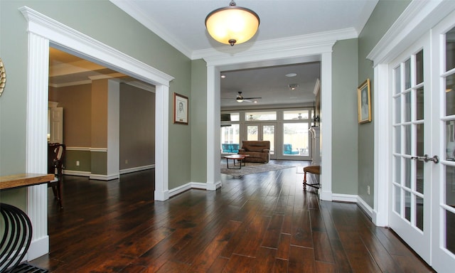 entrance foyer featuring baseboards, ornamental molding, and wood finished floors