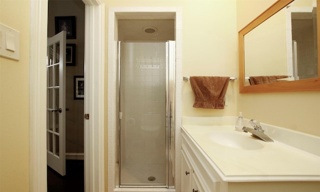 bathroom featuring a shower stall and vanity