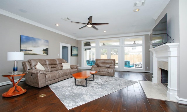 living area with hardwood / wood-style flooring, visible vents, and ornamental molding