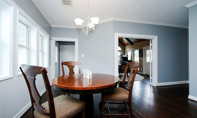 dining area featuring baseboards, visible vents, dark wood-style flooring, crown molding, and a chandelier