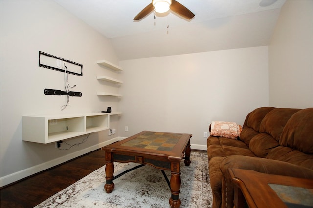 living room featuring vaulted ceiling, baseboards, and wood finished floors