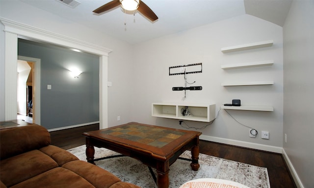 living area with a ceiling fan, visible vents, baseboards, and wood finished floors