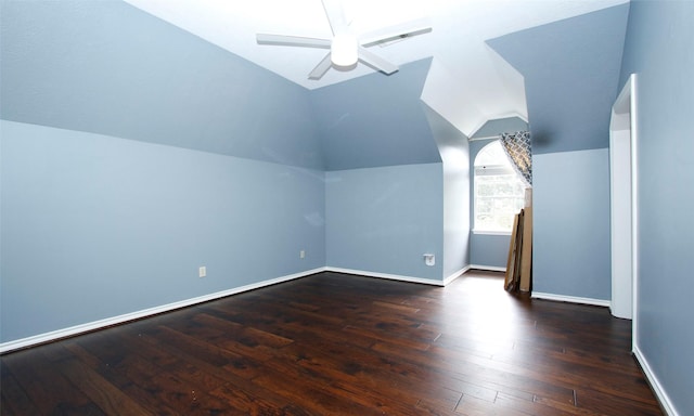 bonus room with lofted ceiling, ceiling fan, baseboards, and dark wood finished floors