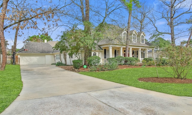 view of front of property with a garage, a front yard, and concrete driveway