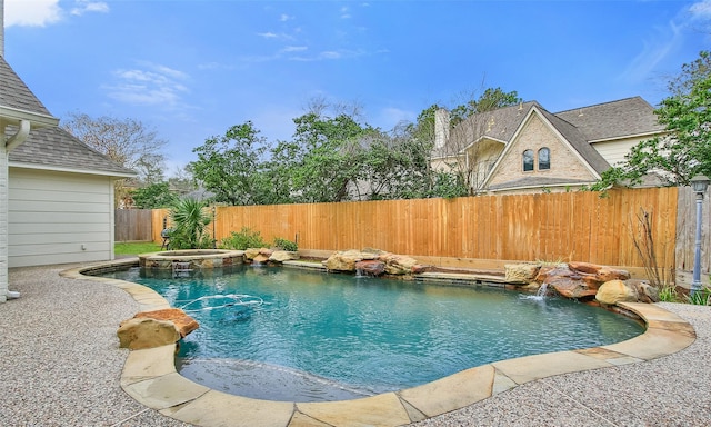 view of pool featuring a pool with connected hot tub and fence