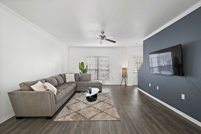 living room with ornamental molding, dark wood-style flooring, ceiling fan, and baseboards