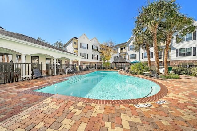 pool featuring a patio area and fence