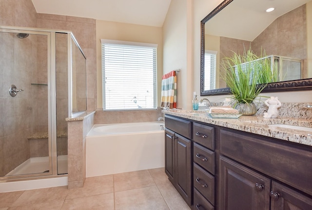 bathroom featuring tile patterned flooring, a shower stall, a bath, and a sink