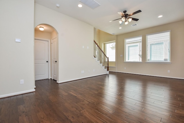 spare room with dark wood-style floors, visible vents, and plenty of natural light