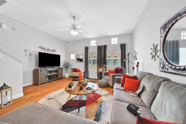 living area with ceiling fan, light wood finished floors, and baseboards