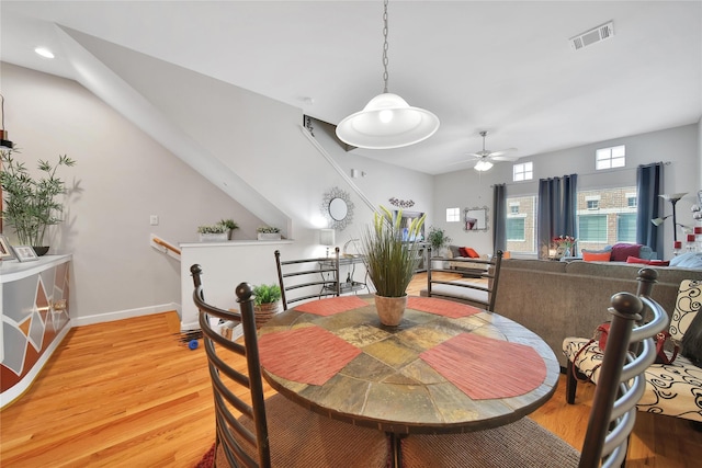 dining room with a ceiling fan, light wood-style flooring, visible vents, and baseboards