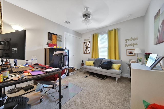 carpeted office with visible vents, ceiling fan, and baseboards