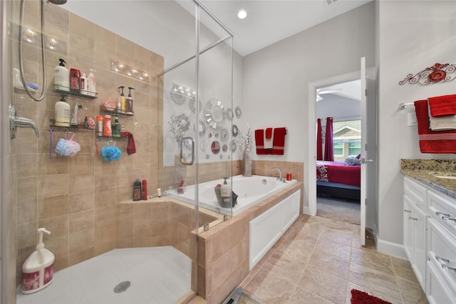 ensuite bathroom featuring a bath, a shower stall, vanity, and ensuite bathroom