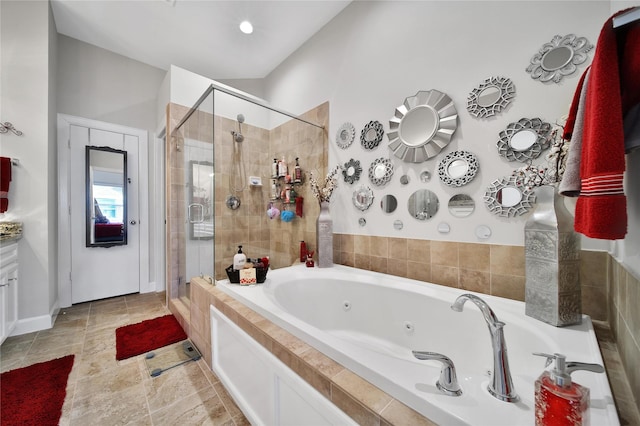 full bathroom featuring a tub with jets and a shower stall