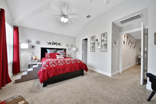 bedroom featuring carpet floors, baseboards, visible vents, and vaulted ceiling