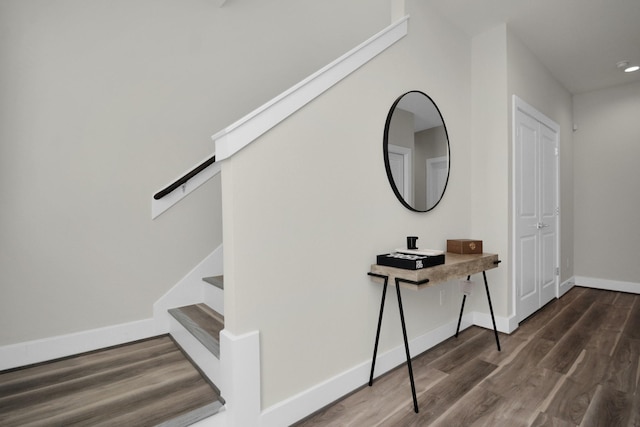 stairway featuring baseboards and wood finished floors