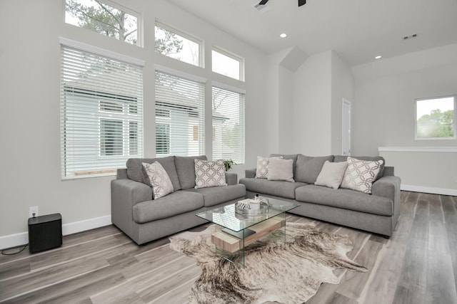 living area featuring recessed lighting, visible vents, a ceiling fan, wood finished floors, and baseboards