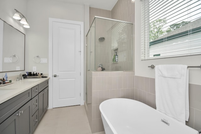 full bath featuring double vanity, a shower stall, a sink, and a freestanding bath