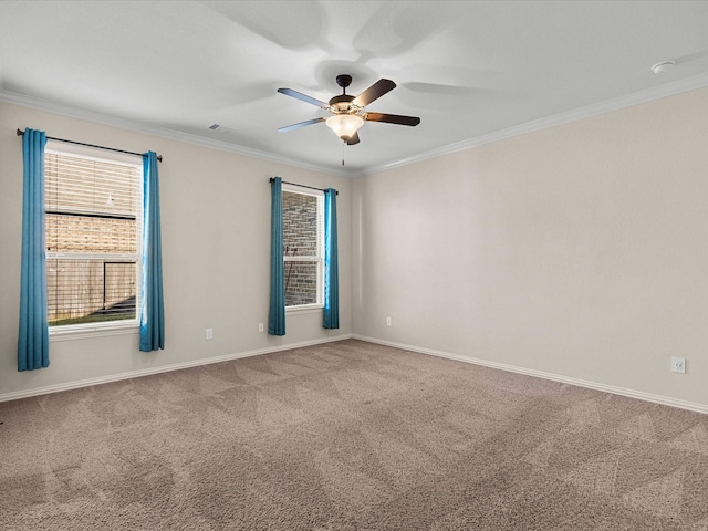 spare room featuring carpet flooring, a ceiling fan, and crown molding