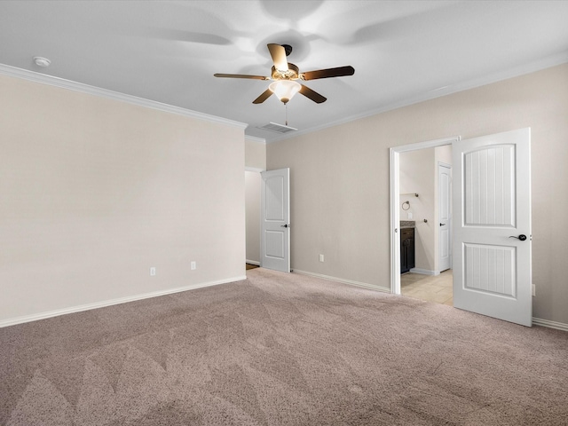 interior space with light colored carpet, visible vents, crown molding, and baseboards